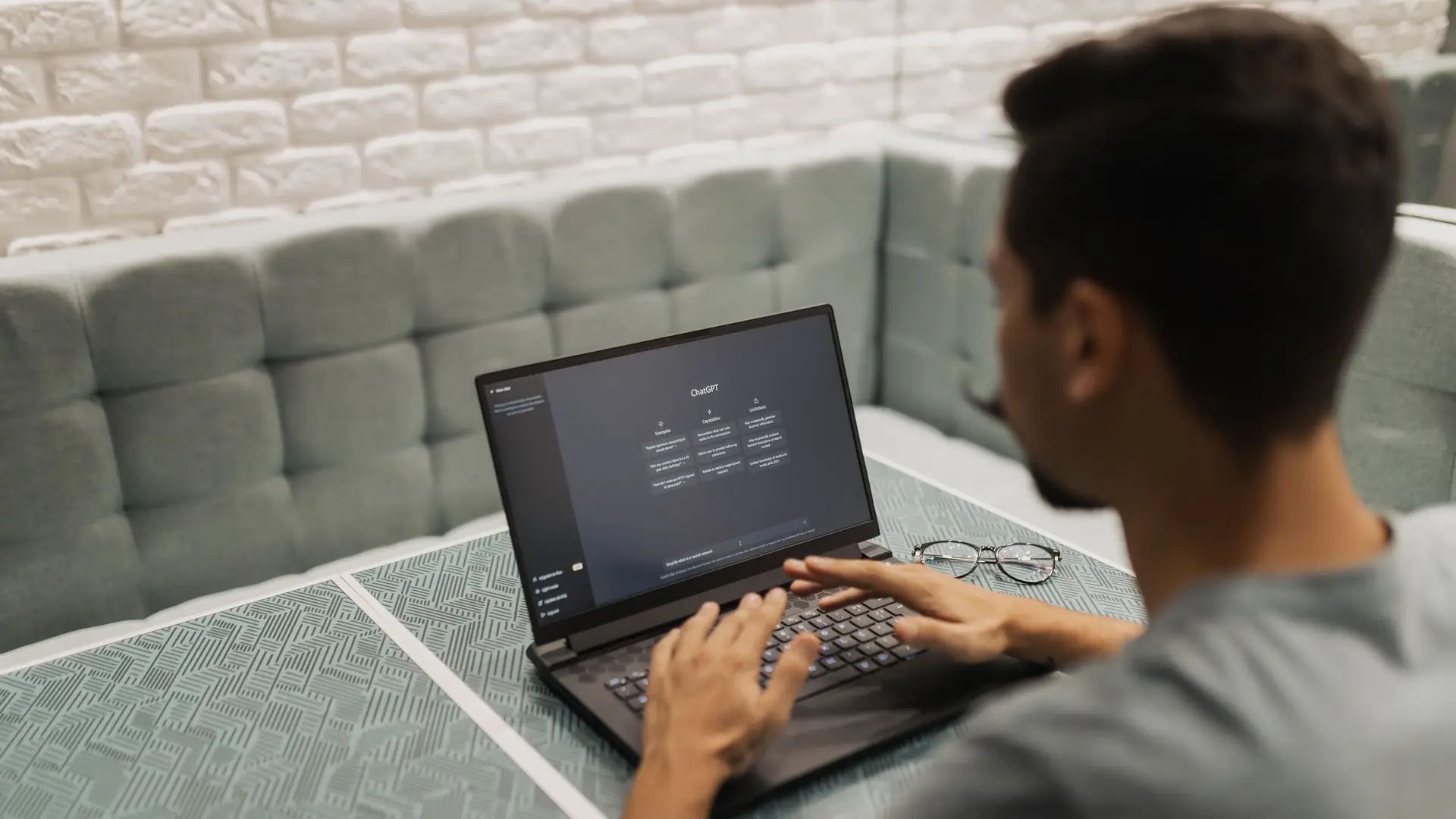 A person using an AI chat tool on a laptop in a bright room
